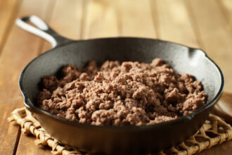 browned ground beef in cast iron skillet