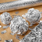 Crumpled balls and pieces of aluminium foil